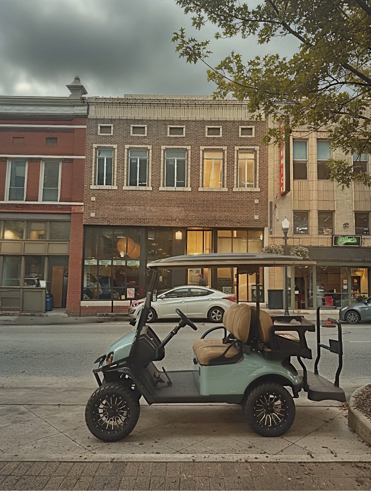 The baby blue 5 Points Cara golf cart parked in front of Southside Cocktails